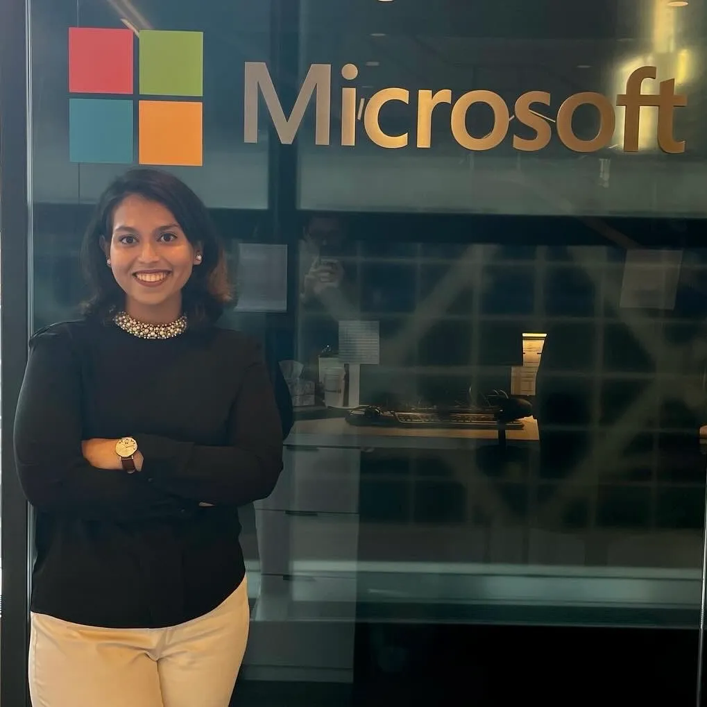 Farnaz standing in front of a Microsoft sign