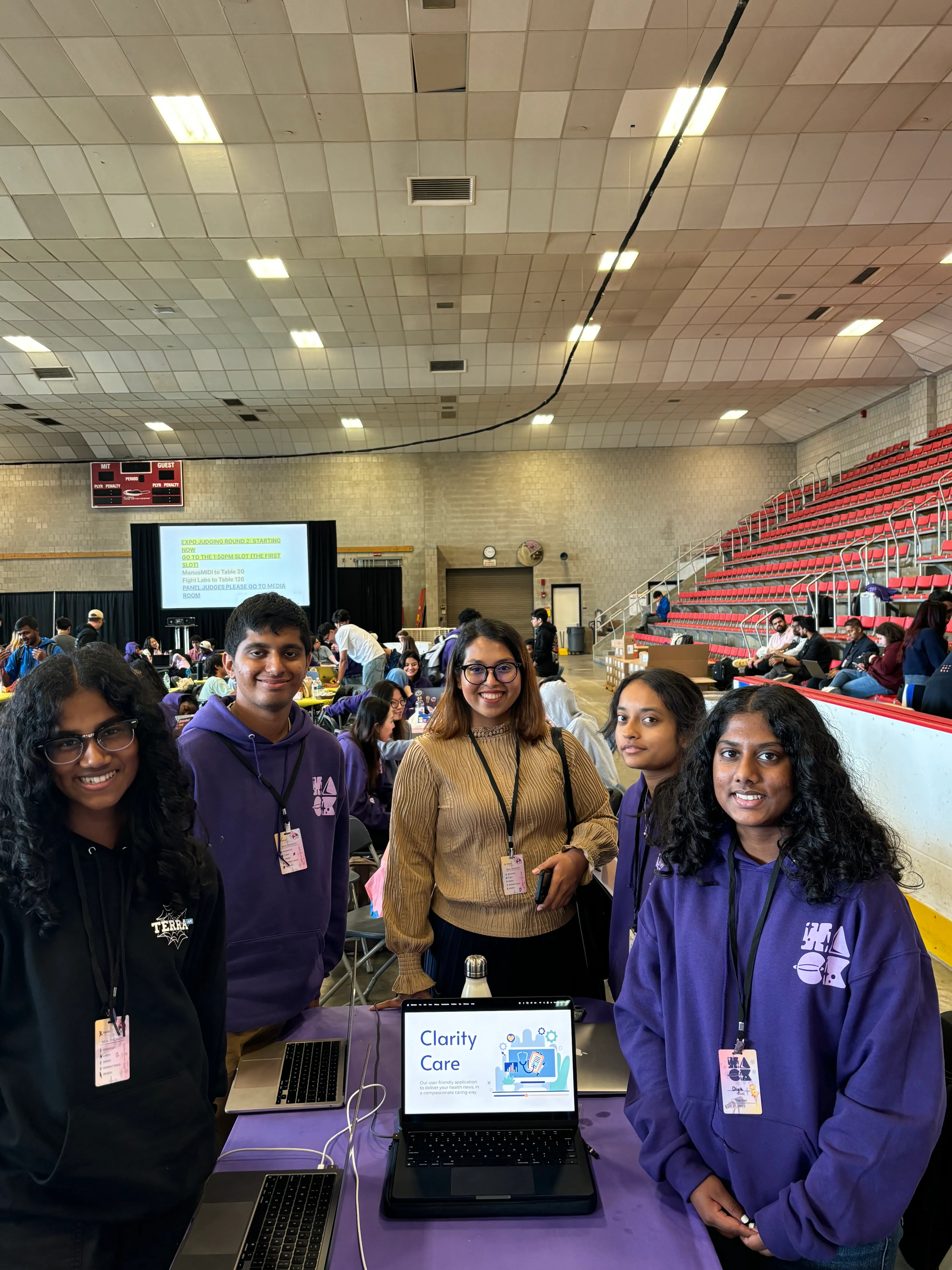 Farnaz with a hackathon team beside their project