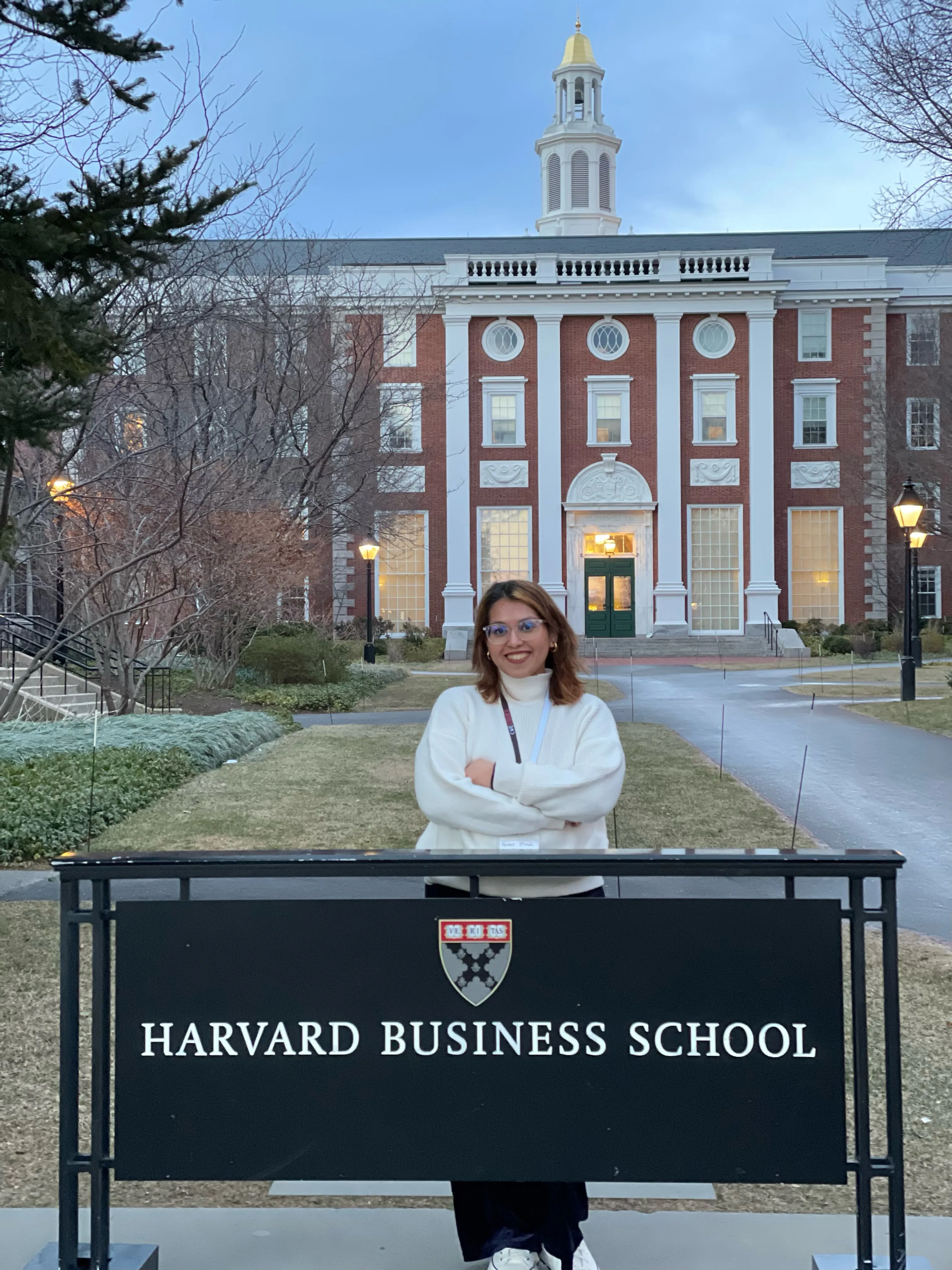 Farnaz standing outside Harvard Business School